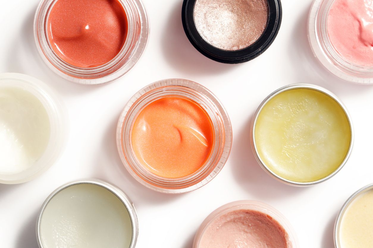 Colorful and fun skincare products lined up next to one another in various creams and powders