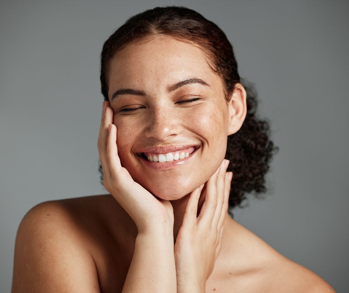 A young woman relishes in her smooth skin and healthy skin microbiome