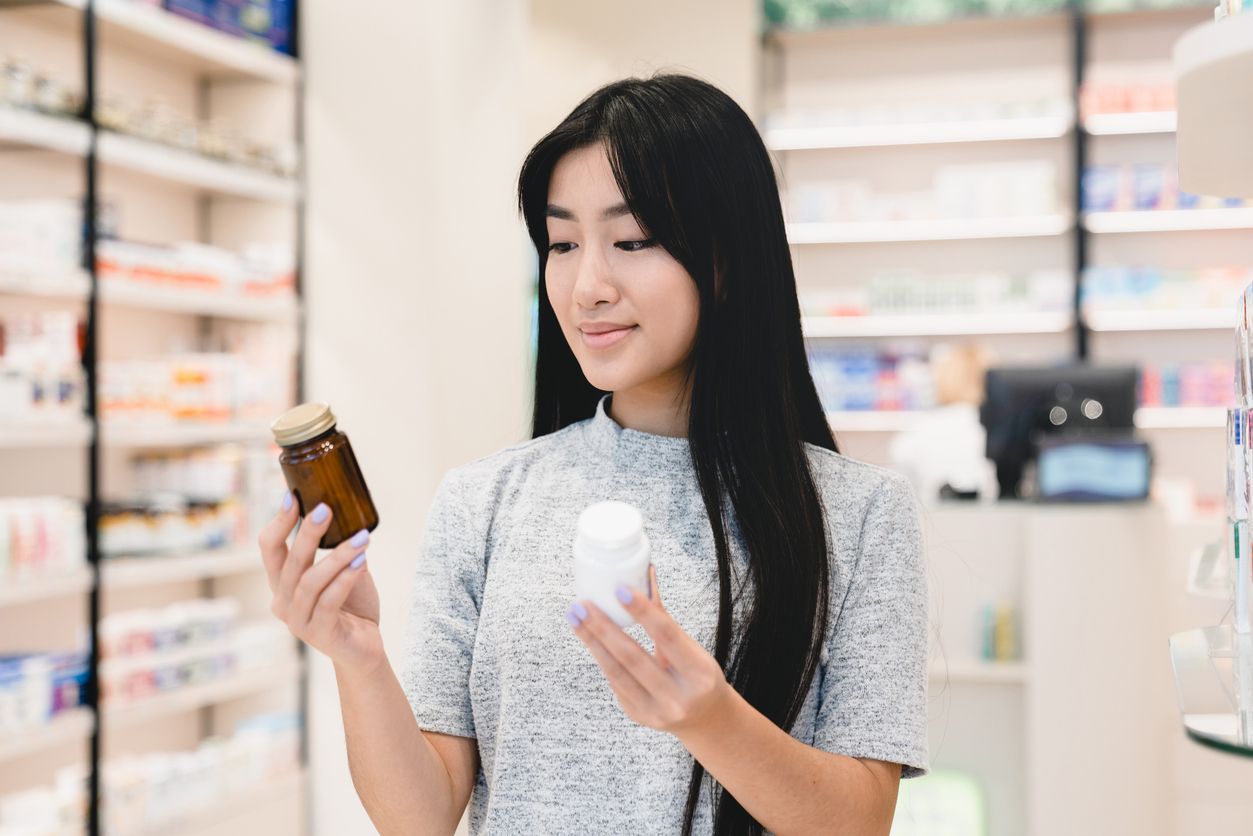 Young woman examining skincare product labels