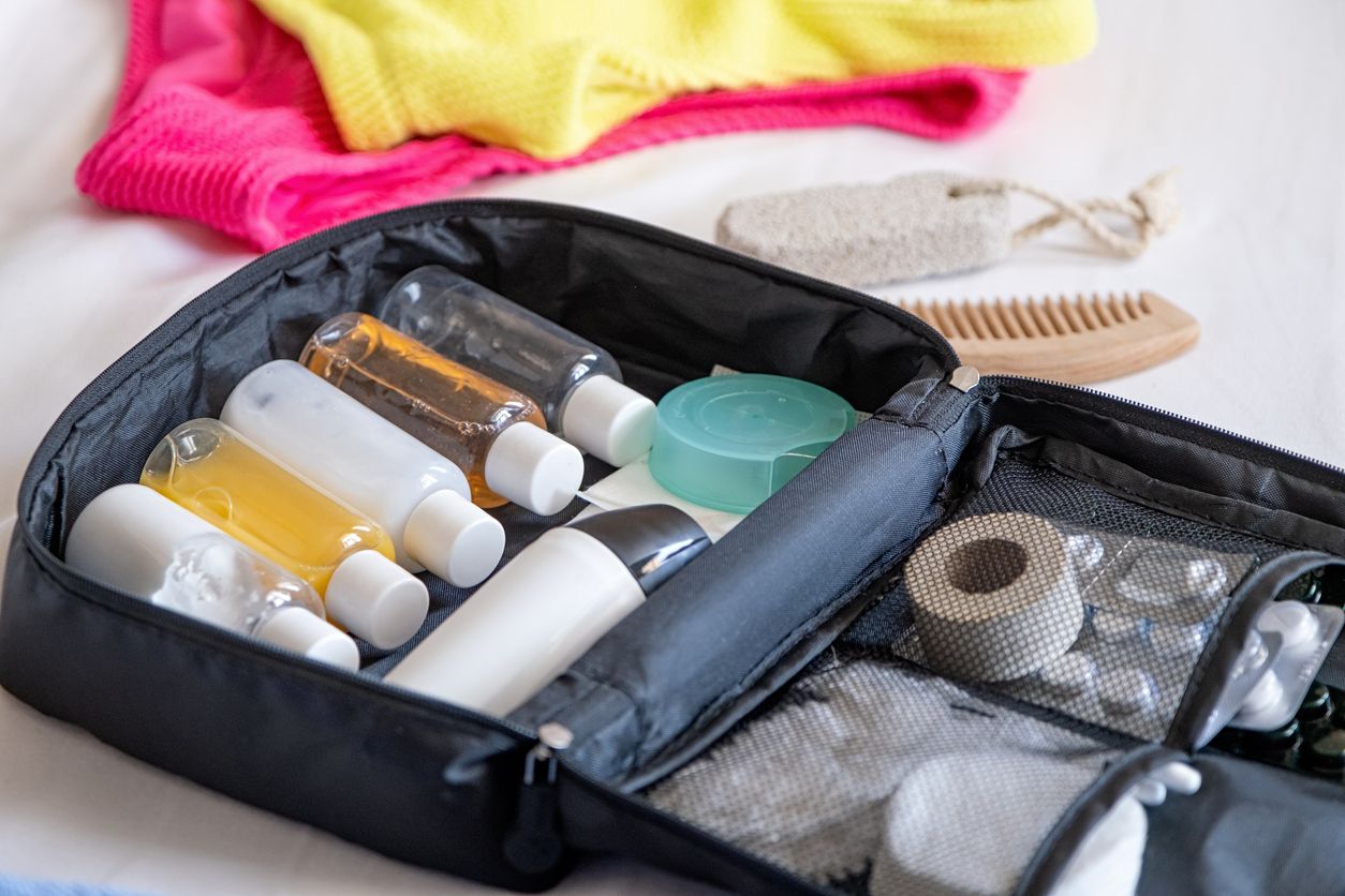 A travel bag with skincare products packed neatly inside