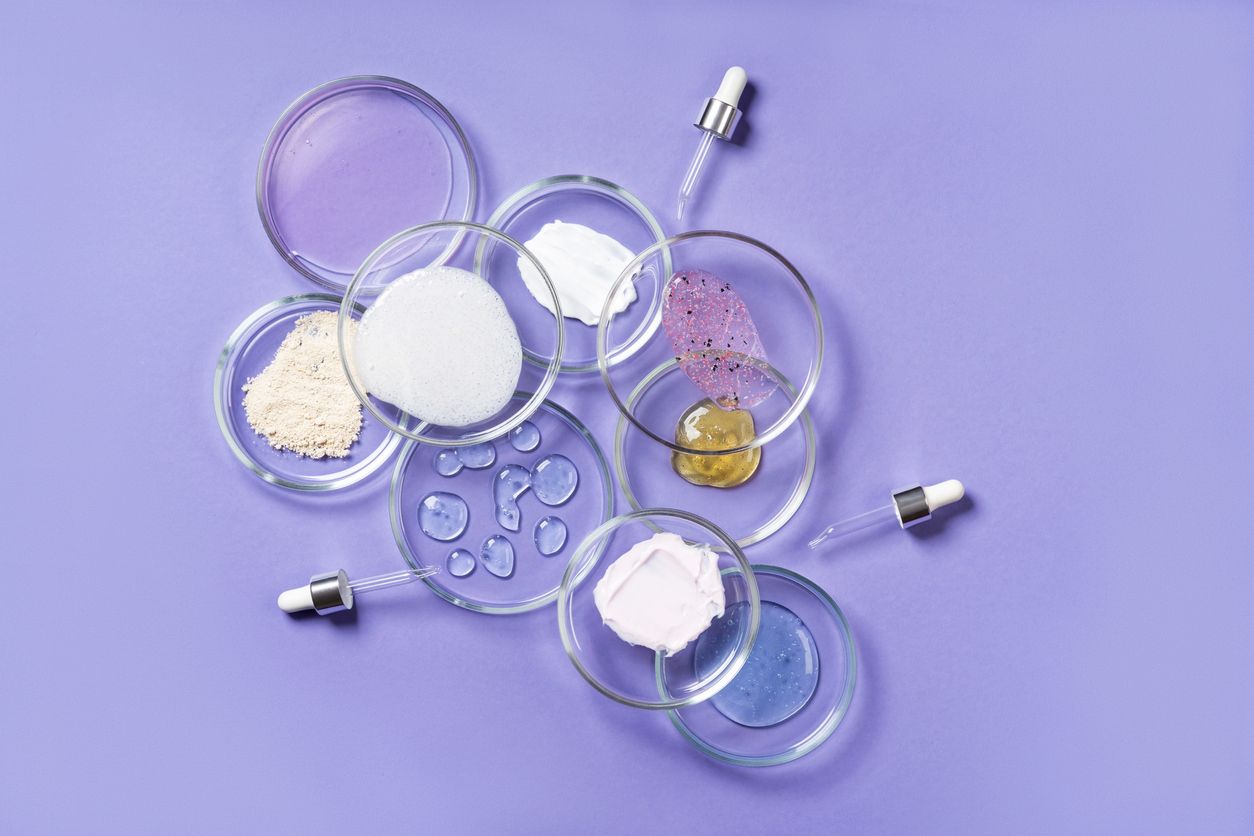 Petri dishes filled with various ingredients of Peach & Lily's toxin-free, vegan, gluten-free, and fragrance free products